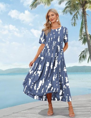 Woman wearing a blue and white patterned maxi dress by a tropical seaside.